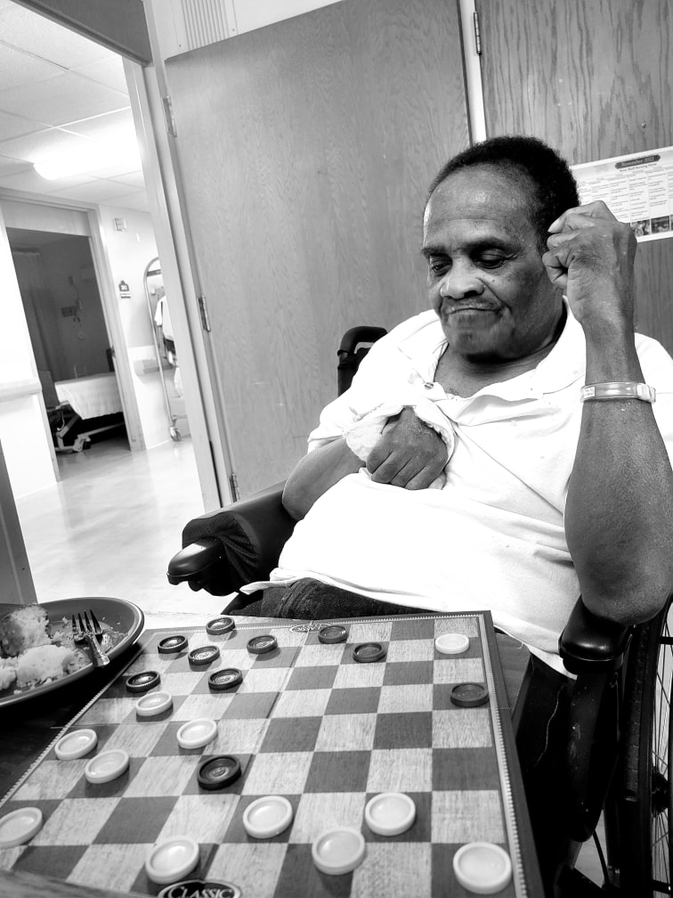Father playing checkers — a quiet moment of strength